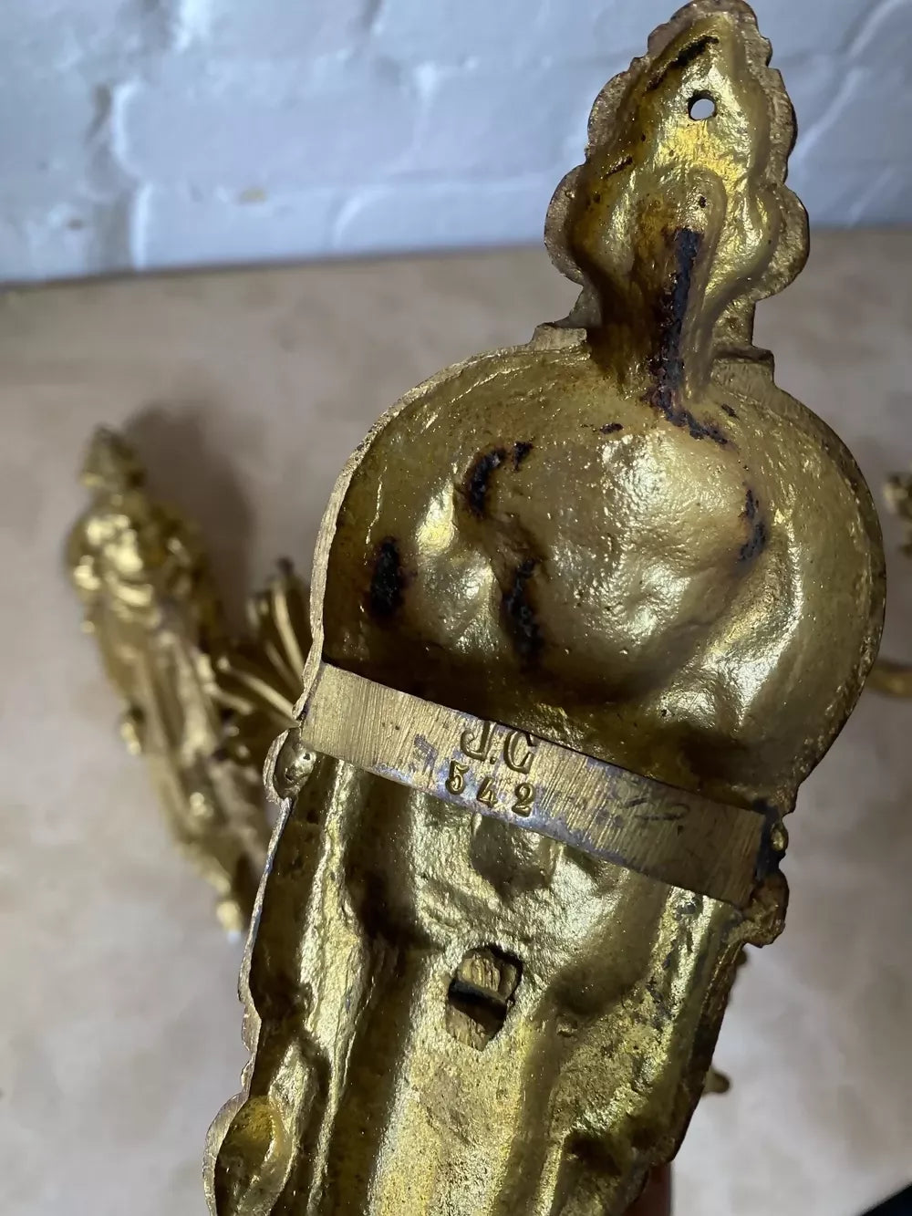 Two ornate bronze wall sconces on a marble surface available to buy from the-salon.com. SALON curates the finest unique handmade pieces from the interior industry's best makers and brands. Shop luxury furniture, lighting, rugs, art, antiques and vintage pieces and accessories from SALON interior designed rooms.