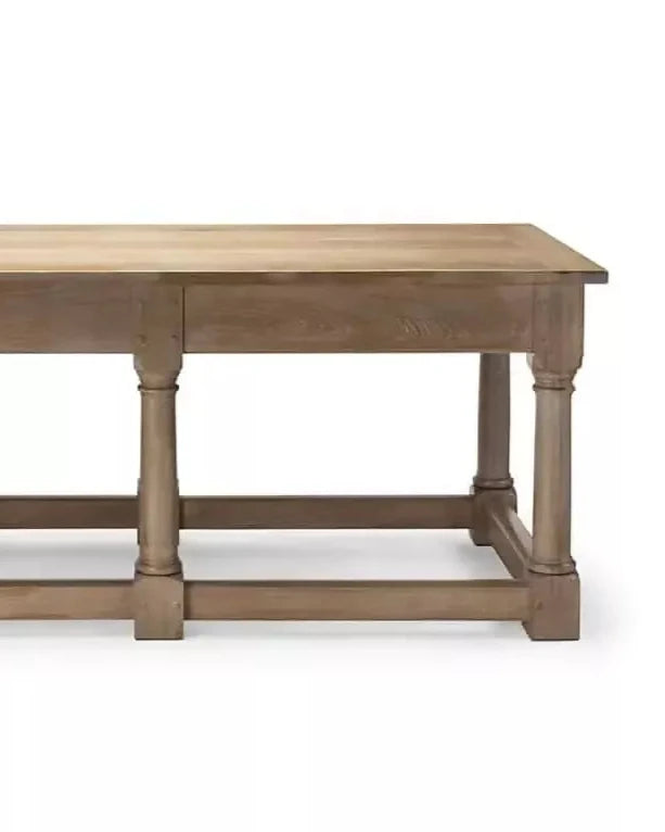 A rectangular wooden refectory table with a drawer at each end and columnar supports, designed in a natural brown finish,  available  to buy on the-salon.com. SALON curates the finest , unique, handmade pieces from the interior industry's best makers and brands. Shop luxury furniture, lighting, rugs, art, antiques and vintage pieces and accessories from SALON interior designed rooms.