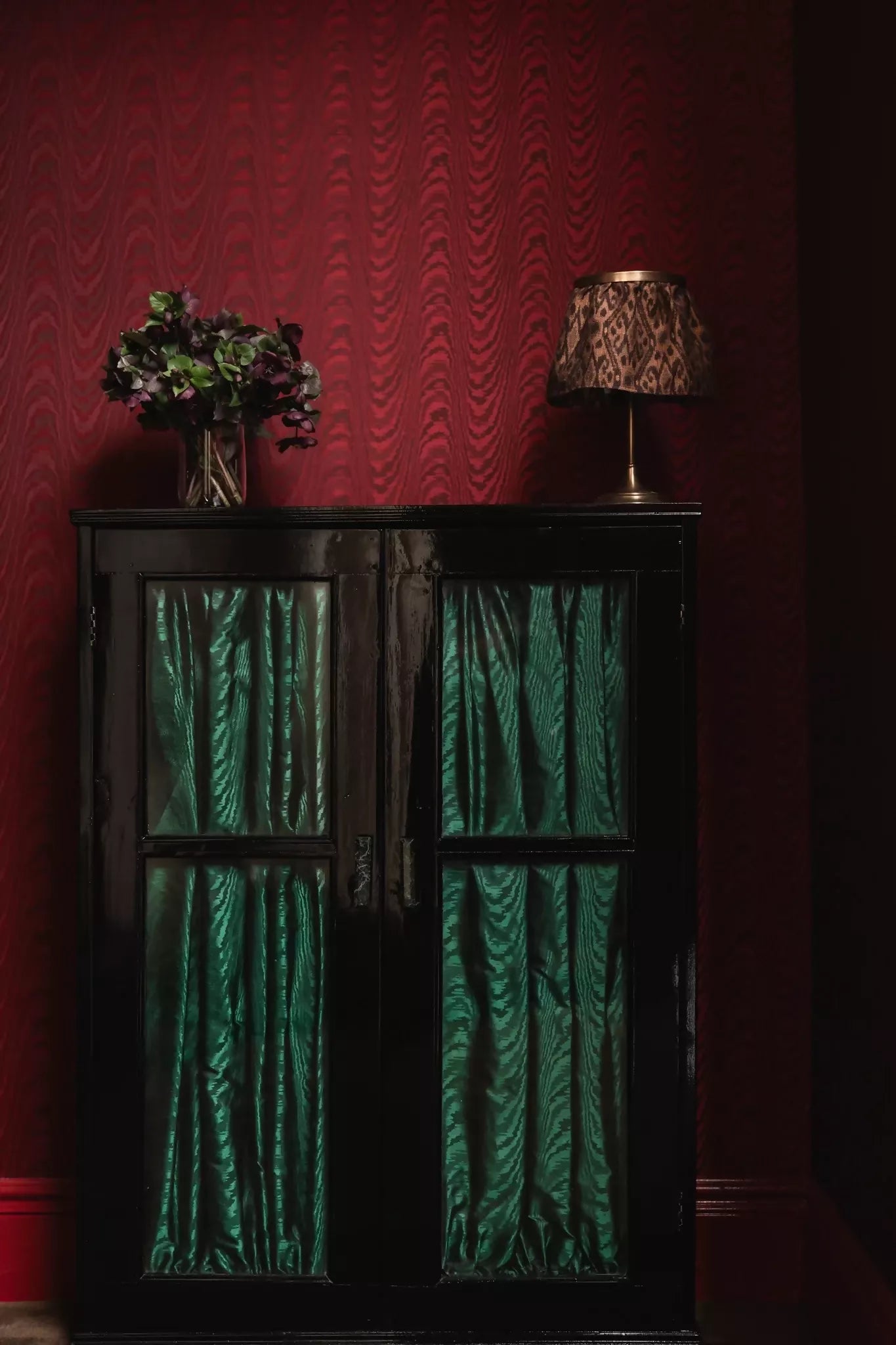 Close-up view of a green silk moiré fabric with a textured pattern as cabinet shutters,  available  to buy on the-salon.com. SALON curates the finest , unique, handmade pieces from the interior industry's best makers and brands. Shop luxury furniture, lighting, rugs, art, antiques and vintage pieces and accessories from SALON interior designed rooms.