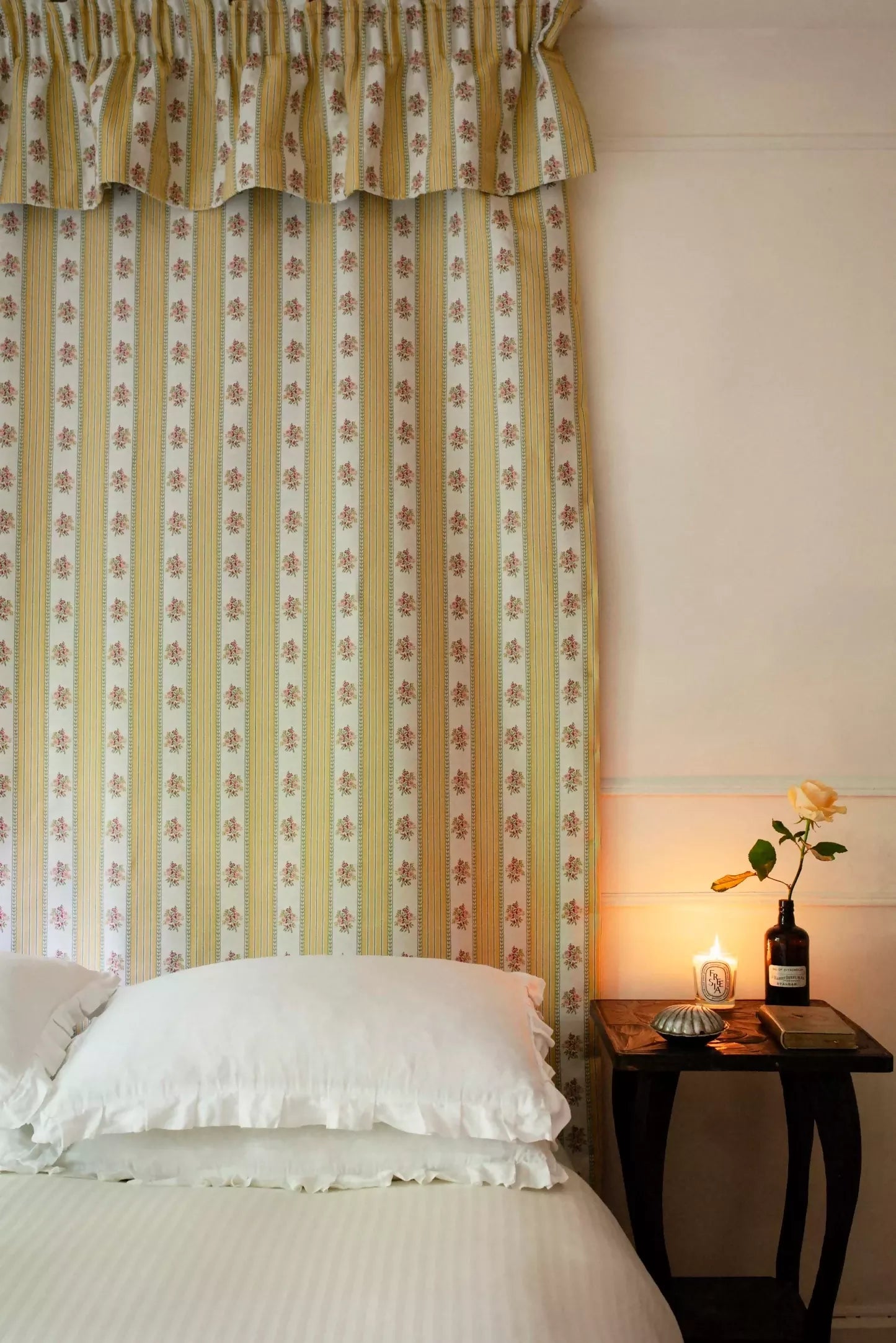 A view of a jacquard weave fabric featuring a curtian stripe pattern with yellow and green stripes and embroidered floral motifs,  available  to buy on the-salon.com. SALON curates the finest , unique, handmade pieces from the interior industry's best makers and brands. Shop luxury furniture, lighting, rugs, art, antiques and vintage pieces and accessories from SALON interior designed rooms.
