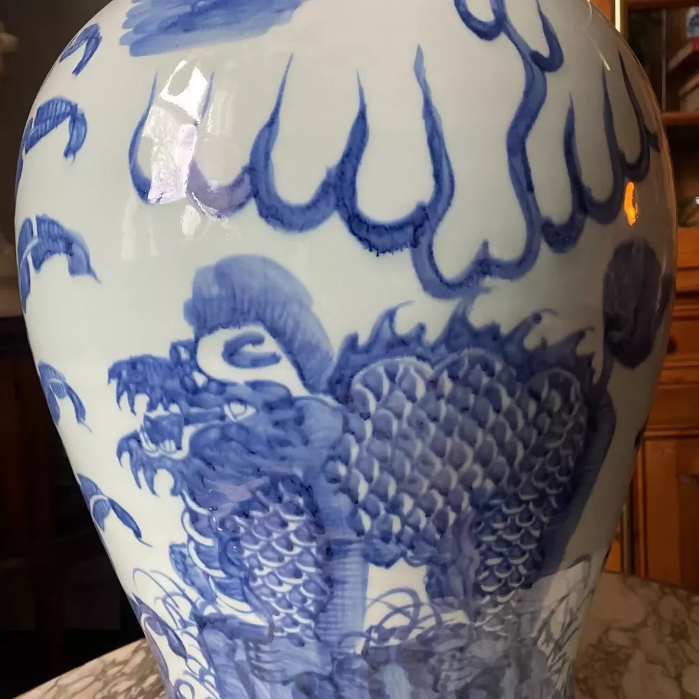 Blue and white decorative vase on a marble table with wooden cabinet in the background,available to buy from the-salon.com. SALON curates the finest unique handmade pieces from the interior industry's best makers and brands. Shop luxury furniture, lighting, rugs, art, antiques and vintage pieces and accessories from SALON interior designed rooms.