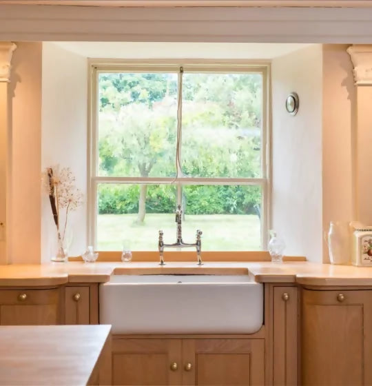 'Rose tinted white' on the walls in a kitchen setting with a sink and a window in view,  available  to buy on the-salon.com. SALON curates the finest , unique, handmade pieces from the interior industry's best makers and brands. Shop luxury furniture, lighting, rugs, art, antiques and vintage pieces and accessories from SALON interior designed rooms.