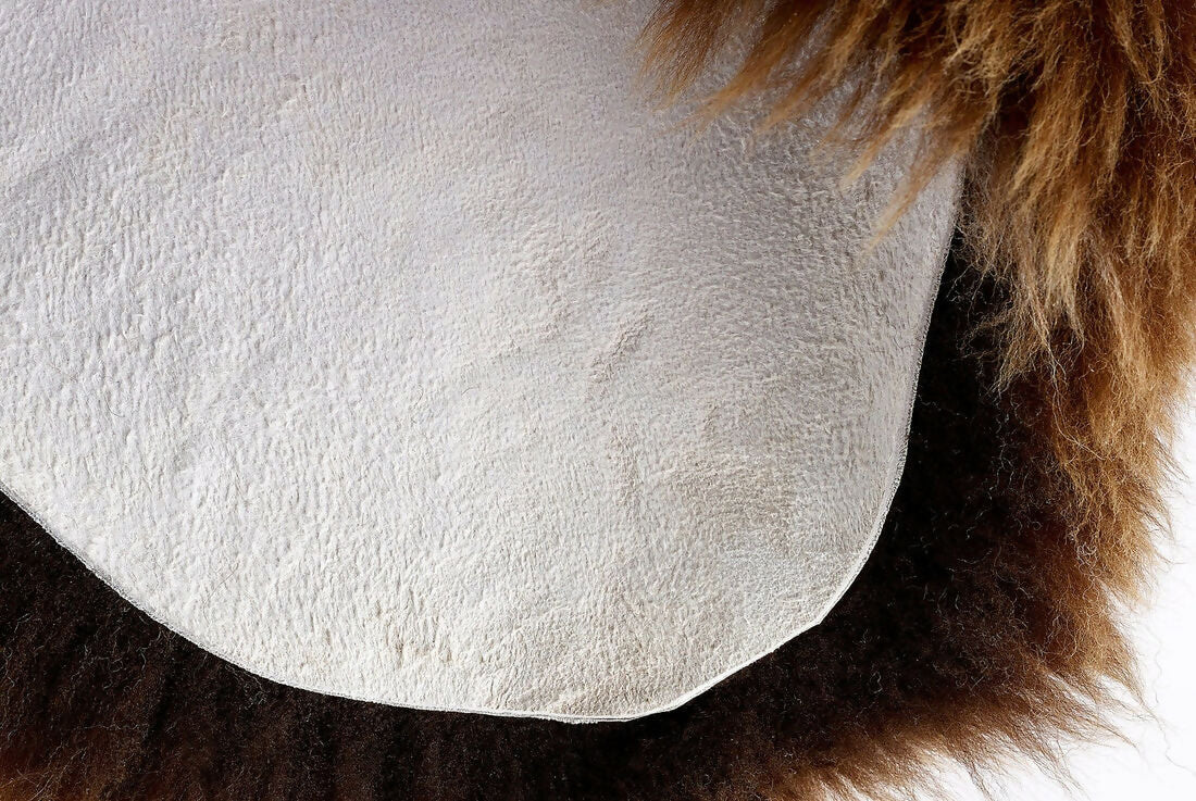 Close up of a brown sheepskin rug. The rug, available to buy from the-salon.com. SALON curates the finest unique handmade pieces from the interior industry's best makers and brands. Shop luxury furniture, lighting, rugs, art, antiques and vintage pieces and accessories from SALON interior designed rooms.