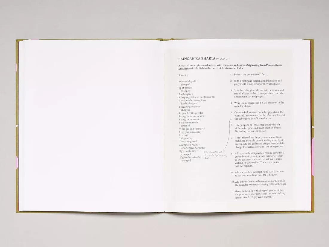 Open book, page open to a recipe of baingan ka bharta and the other page is empty,  available  to buy on the-salon.com. SALON curates the finest , unique, handmade pieces from the interior industry's best makers and brands. Shop luxury furniture, lighting, rugs, art, antiques and vintage pieces and accessories from SALON interior designed rooms.