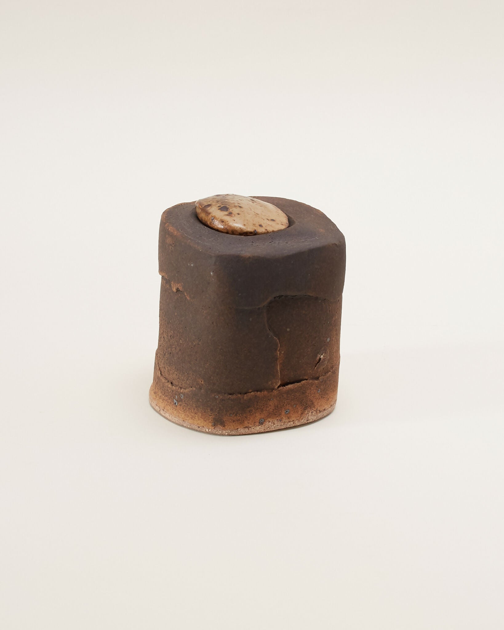 Small brown ceramic box on a white background,  available  to buy on the-salon.com. SALON curates the finest , unique, handmade pieces from the interior industry's best makers and brands. Shop luxury furniture, lighting, rugs, art, antiques and vintage pieces and accessories from SALON interior designed rooms.