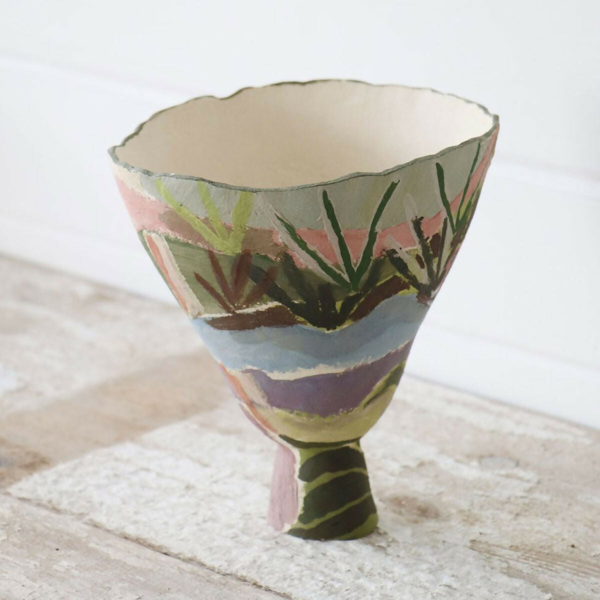 Colorful ceramic bowl with abstract design on a textured surface,  available  to buy on the-salon.com. SALON curates the finest , unique, handmade pieces from the interior industry's best makers and brands. Shop luxury furniture, lighting, rugs, art, antiques and vintage pieces and accessories from SALON interior designed rooms.