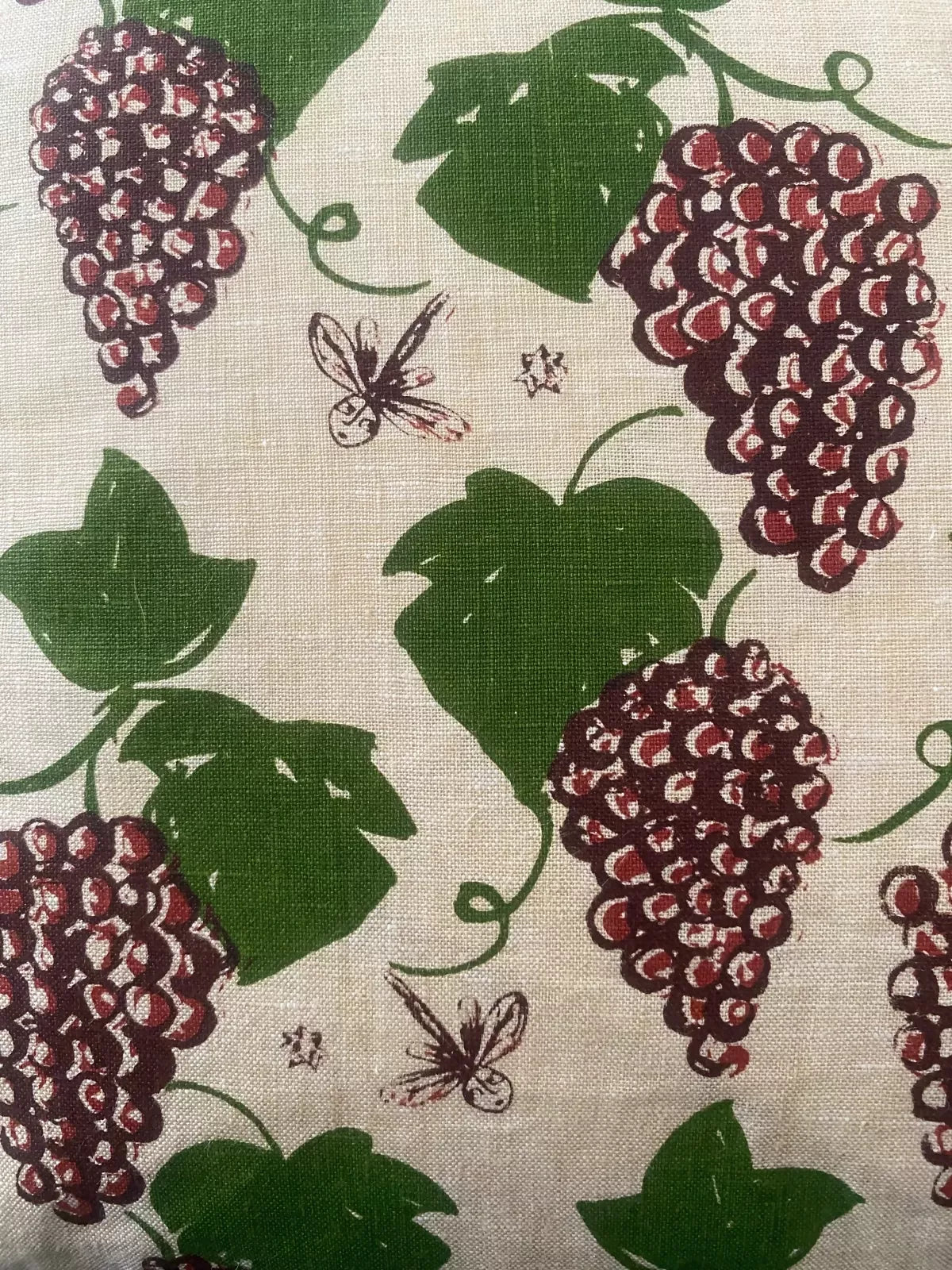 A rectangular cushion with a floral pattern featuring purple grapes and green leaves, ,  available  to buy on the-salon.com. SALON curates the finest , unique, handmade pieces from the interior industry's best makers and brands. Shop luxury furniture, lighting, rugs, art, antiques and vintage pieces and accessories from SALON interior designed rooms.