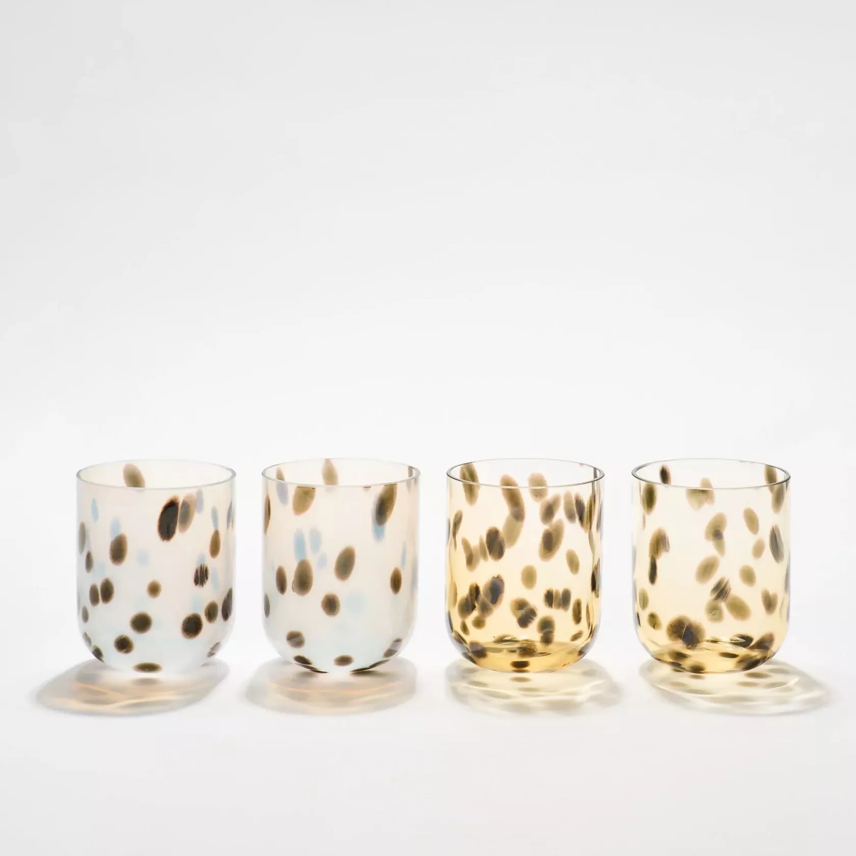 Four glass tumblers with spotted patterns on a white background- available  to buy on the-salon.com. SALON curates the finest , unique, handmade pieces from the interior industry's best makers and brands. Shop luxury furniture, lighting, rugs, art, antiques and vintage pieces and accessories from SALON interior designed rooms.