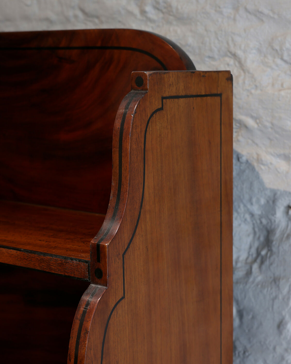 A REGENCY MAHOGANY AND EBONY INLAID WATERFALL BOOKCASE