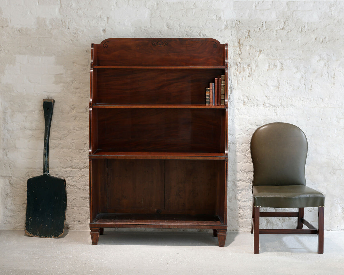 A REGENCY MAHOGANY AND EBONY INLAID WATERFALL BOOKCASE