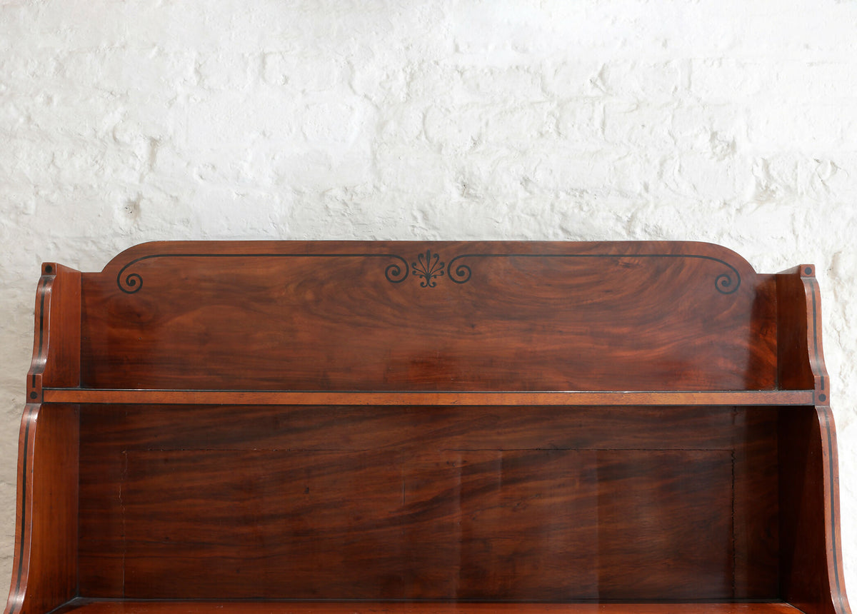 A REGENCY MAHOGANY AND EBONY INLAID WATERFALL BOOKCASE