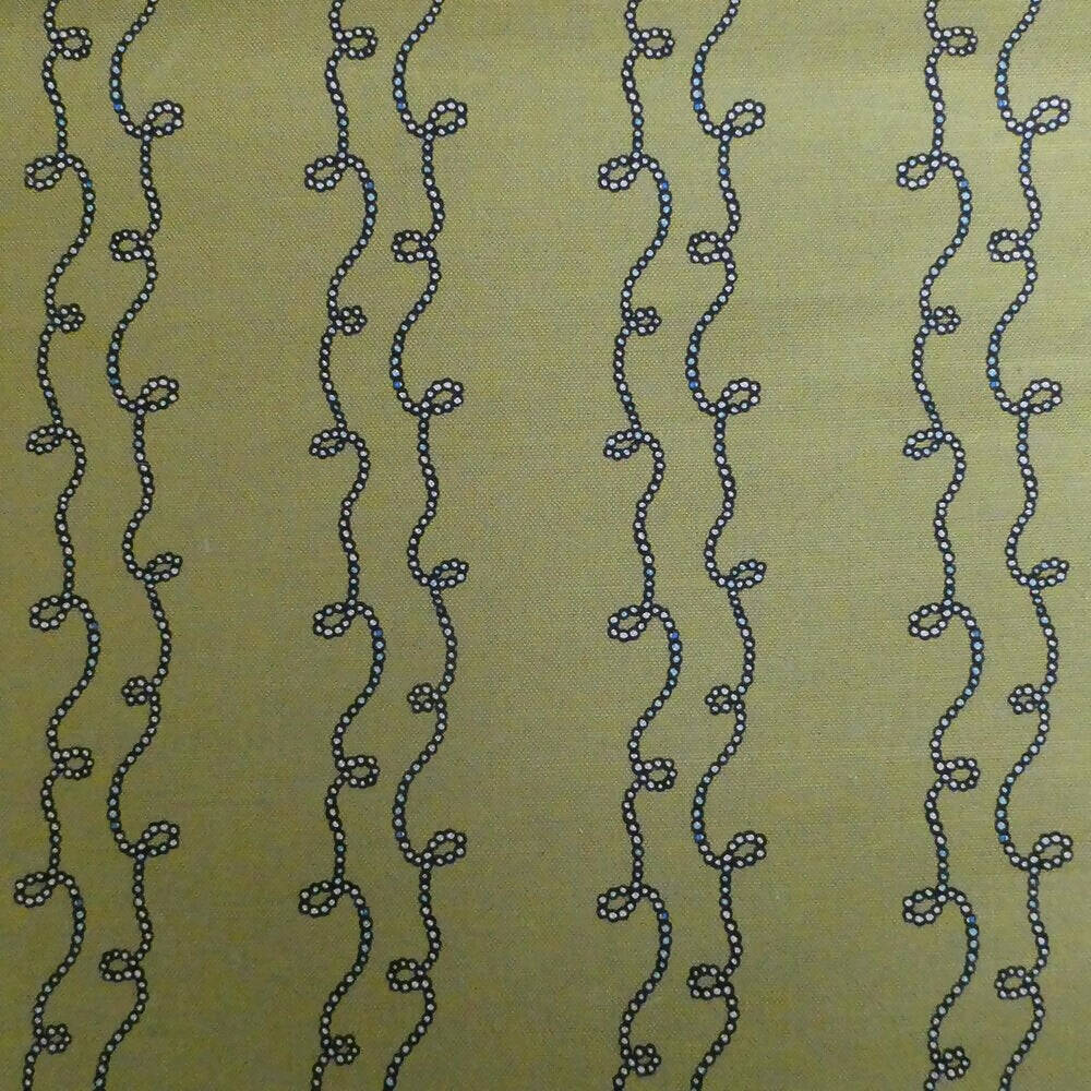 A swatch of fabric featuring a yellow background with a blue geometric pattern consisting of twisted shapes,  available  to buy on the-salon.com. SALON curates the finest , unique, handmade pieces from the interior industry's best makers and brands. Shop luxury furniture, lighting, rugs, art, antiques and vintage pieces and accessories from SALON interior designed rooms.