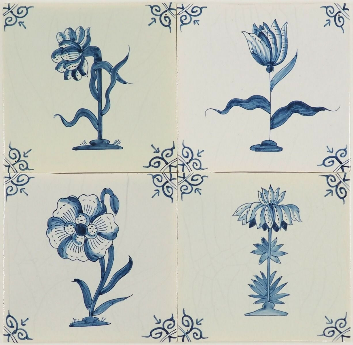 Set of four ceramic tiles with blue floral designs on a white background,  available  to buy on the-salon.com. SALON curates the finest , unique, handmade pieces from the interior industry's best makers and brands. Shop luxury furniture, lighting, rugs, art, antiques and vintage pieces and accessories from SALON interior designed rooms.