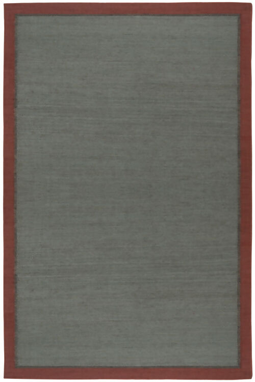 Close-up view of a hand woven dhurrie rug with a plain design and a visible border, available  to buy on the-salon.com. SALON curates the finest , unique, handmade pieces from the interior industry's best makers and brands. Shop luxury furniture, lighting, rugs, art, antiques and vintage pieces and accessories from SALON interior de