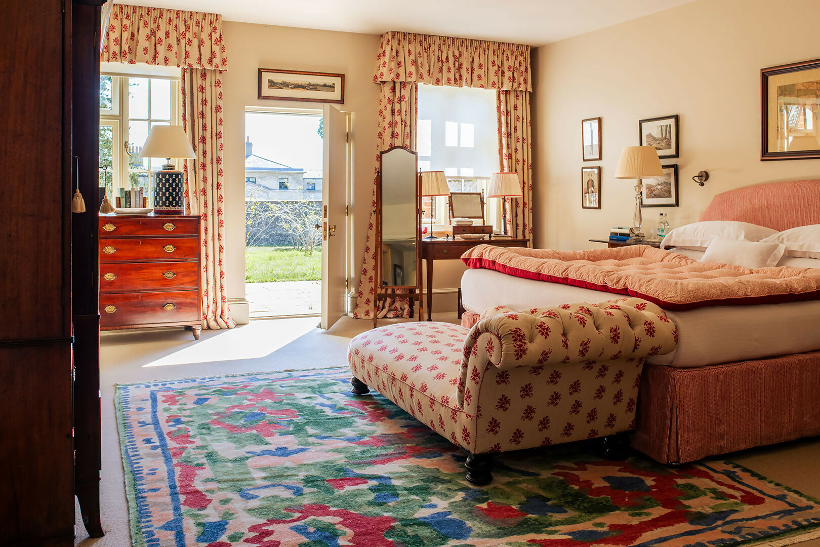 Decorative bedroom with floral rug, bed, and furniture,  available  to buy on the-salon.com. SALON curates the finest , unique, handmade pieces from the interior industry's best makers and brands. Shop luxury furniture, lighting, rugs, art, antiques and vintage pieces and accessories from SALON interior designed rooms.