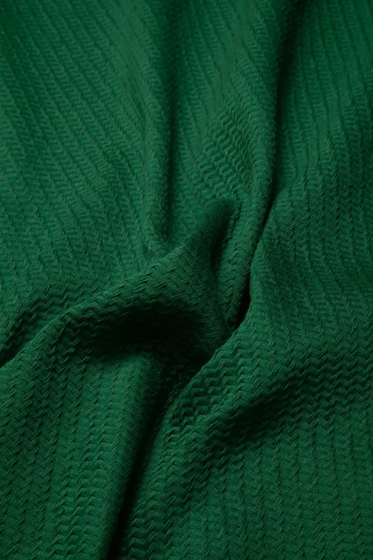 A close-up image of green repp fabric, displaying its texture and solid colour,  available  to buy on the-salon.com. SALON curates the finest , unique, handmade pieces from the interior industry's best makers and brands. Shop luxury furniture, lighting, rugs, art, antiques and vintage pieces and accessories from SALON interior designed rooms.