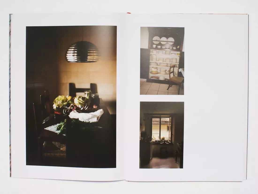 An open book, the pages containing images of a dinning room and a kitchen in low lighting,  available  to buy on the-salon.com. SALON curates the finest , unique, handmade pieces from the interior industry's best makers and brands. Shop luxury furniture, lighting, rugs, art, antiques and vintage pieces and accessories from SALON interior designed rooms.
