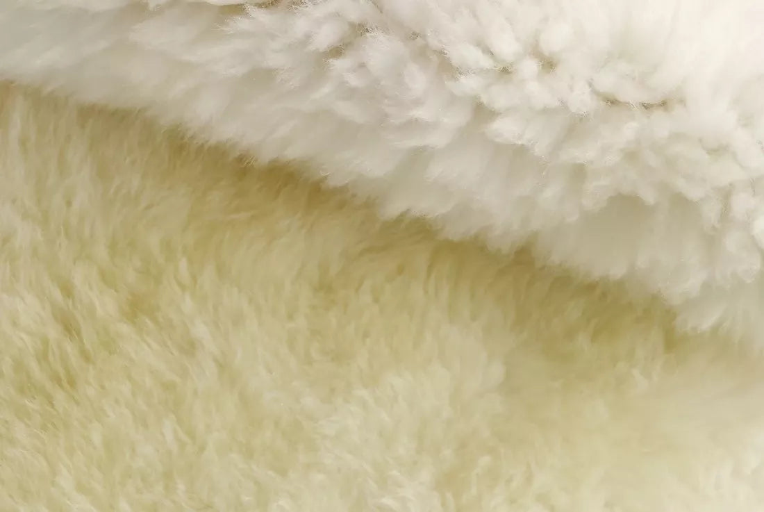 Close up of a white sheepskin rug. The rug, available to buy from the-salon.com. SALON curates the finest unique handmade pieces from the interior industry's best makers and brands. Shop luxury furniture, lighting, rugs, art, antiques and vintage pieces and accessories from SALON interior designed rooms.