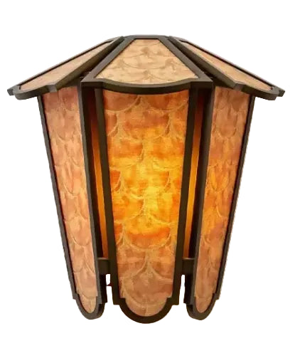 A decorative wall sconce with a geometric, multi-sided design, featuring warm amber and orange stained glass panels framed in dark metal, shown against a plain white background.