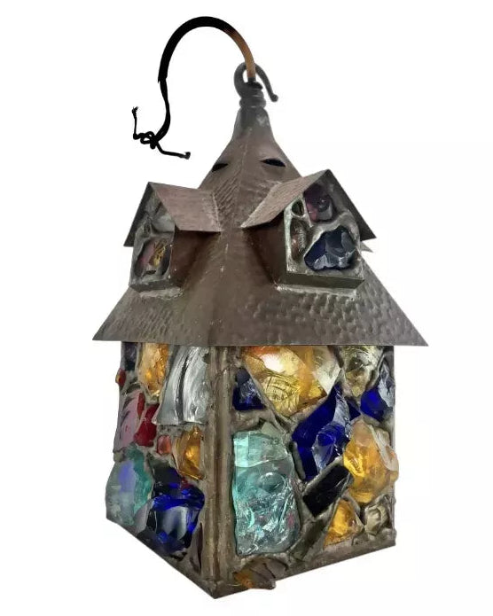 A decorative hanging lantern with a hammered metal frame and colorful stained-glass panels in blue, yellow, and clear glass, shown against a plain white background.