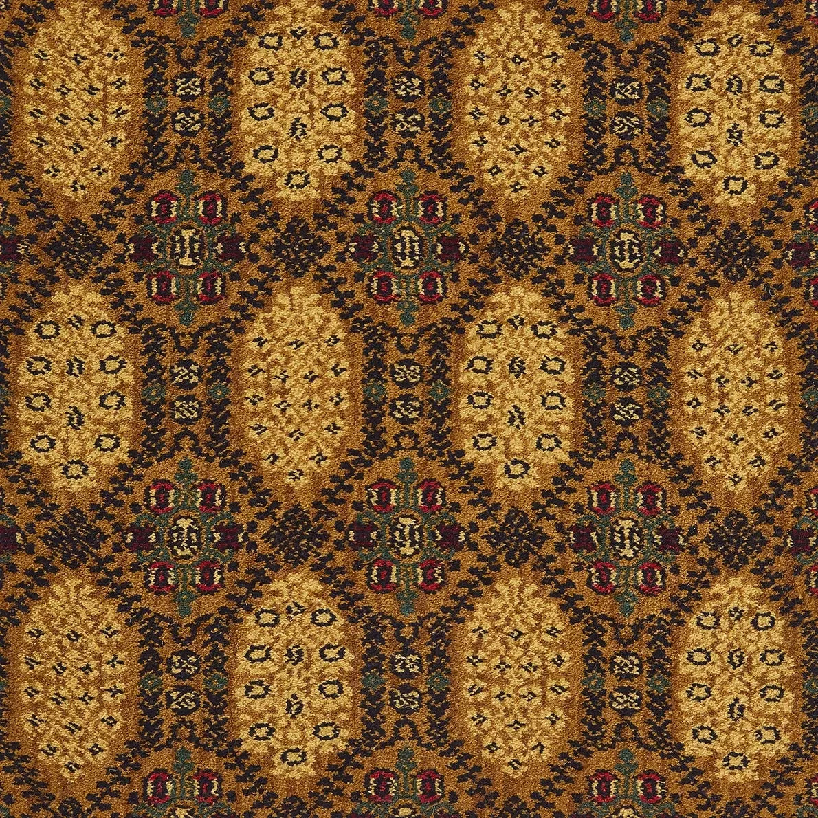 A close-up of a patterned fabric or wallpaper showing a repeating geometric and floral motif in warm gold, brown, black, and muted red accents.