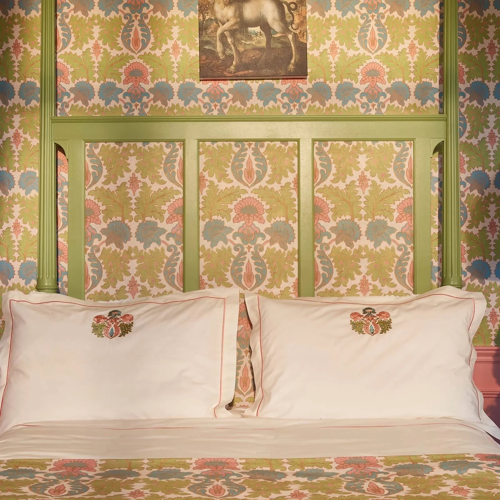 Decorative headboard with patterned wallpaper and embroidered pillows,  available  to buy on the-salon.com. SALON curates the finest , unique, handmade pieces from the interior industry's best makers and brands. Shop luxury furniture, lighting, rugs, art, antiques and vintage pieces and accessories from SALON interior designed rooms.