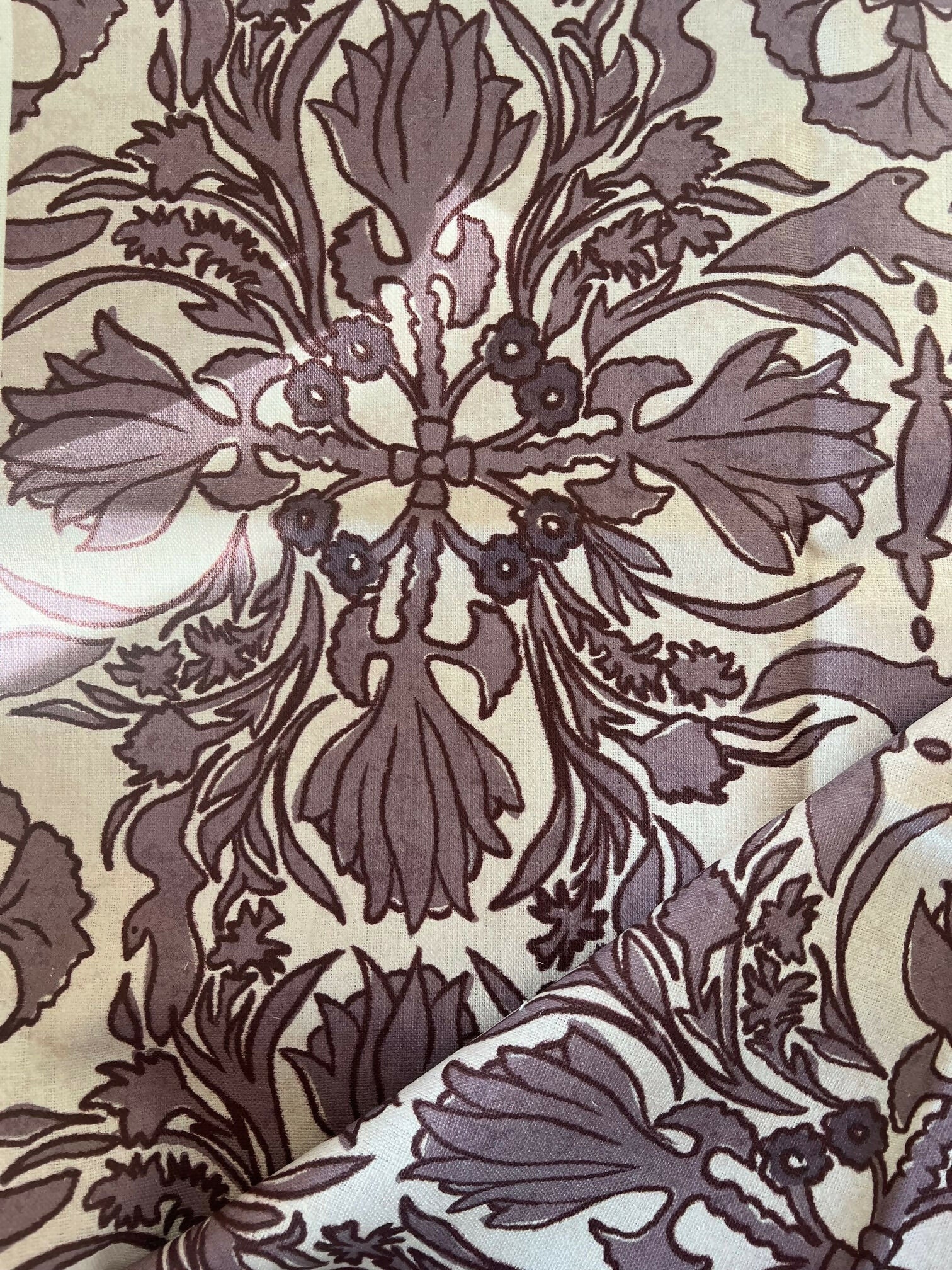 A close-up view of a vintage scarf fabric featuring a detailed and ornate floral pattern in shades of black and gray on a beige background,  available  to buy on the-salon.com. SALON curates the finest , unique, handmade pieces from the interior industry's best makers and brands. Shop luxury furniture, lighting, rugs, art, antiques and vintage pieces and accessories from SALON interior designed rooms.