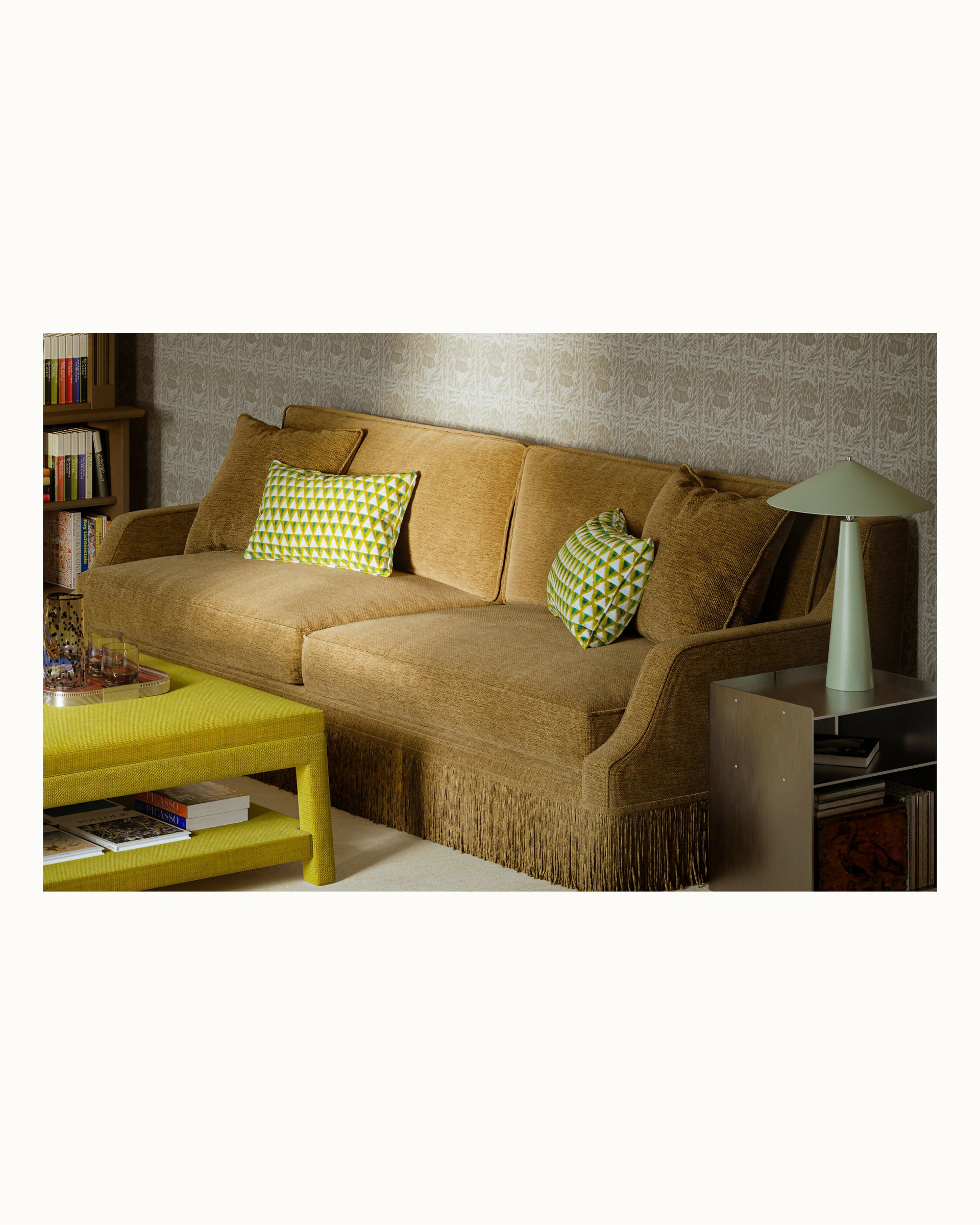 Brown sofa with green cushions in a living room setting,  available  to buy on the-salon.com. SALON curates the finest , unique, handmade pieces from the interior industry's best makers and brands. Shop luxury furniture, lighting, rugs, art, antiques and vintage pieces and accessories from SALON interior designed rooms.