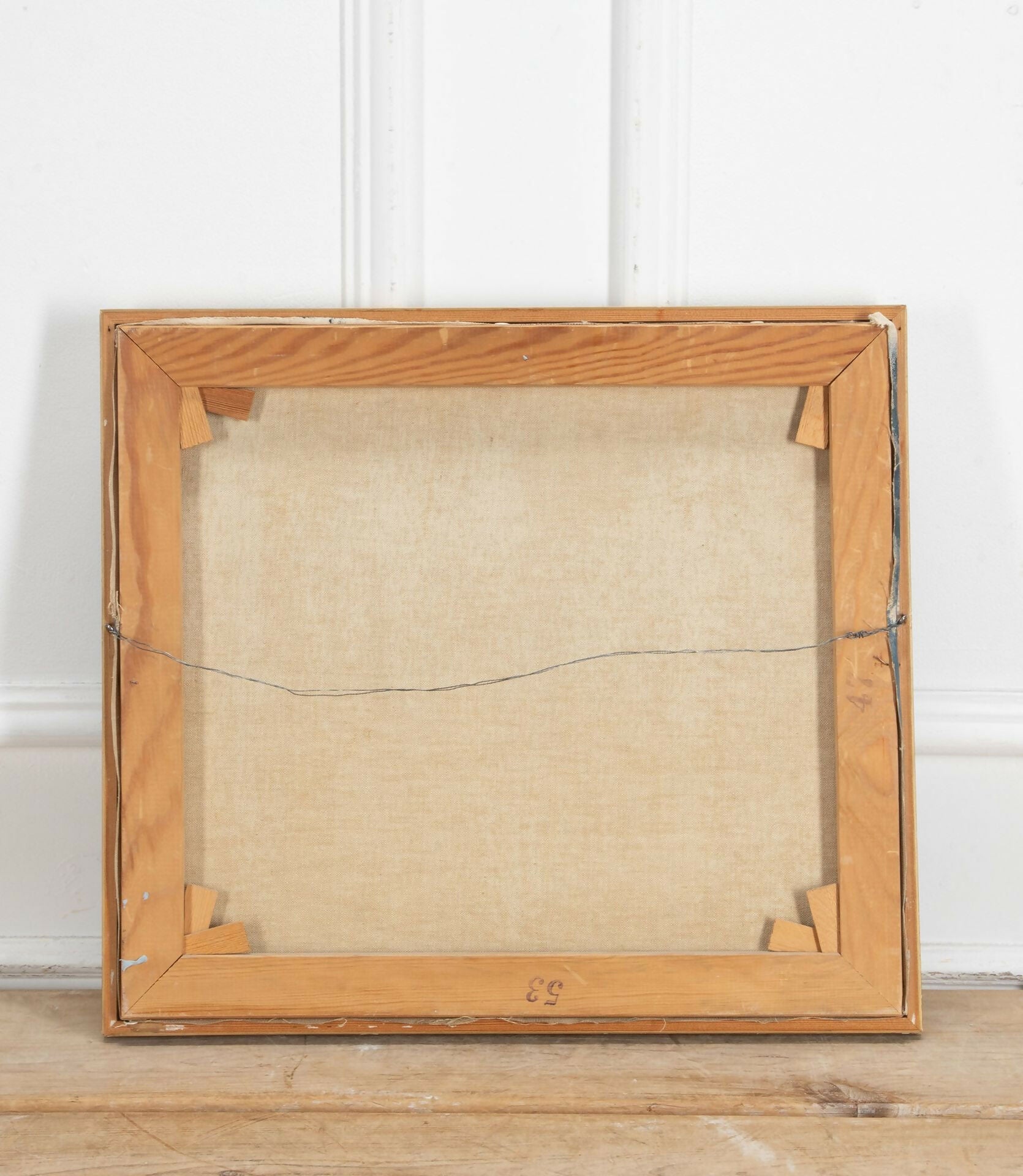 Wooden picture frame with a textured back on a wooden surface,  available  to buy on the-salon.com. SALON curates the finest , unique, handmade pieces from the interior industry's best makers and brands. Shop luxury furniture, lighting, rugs, art, antiques and vintage pieces and accessories from SALON interior designed rooms.