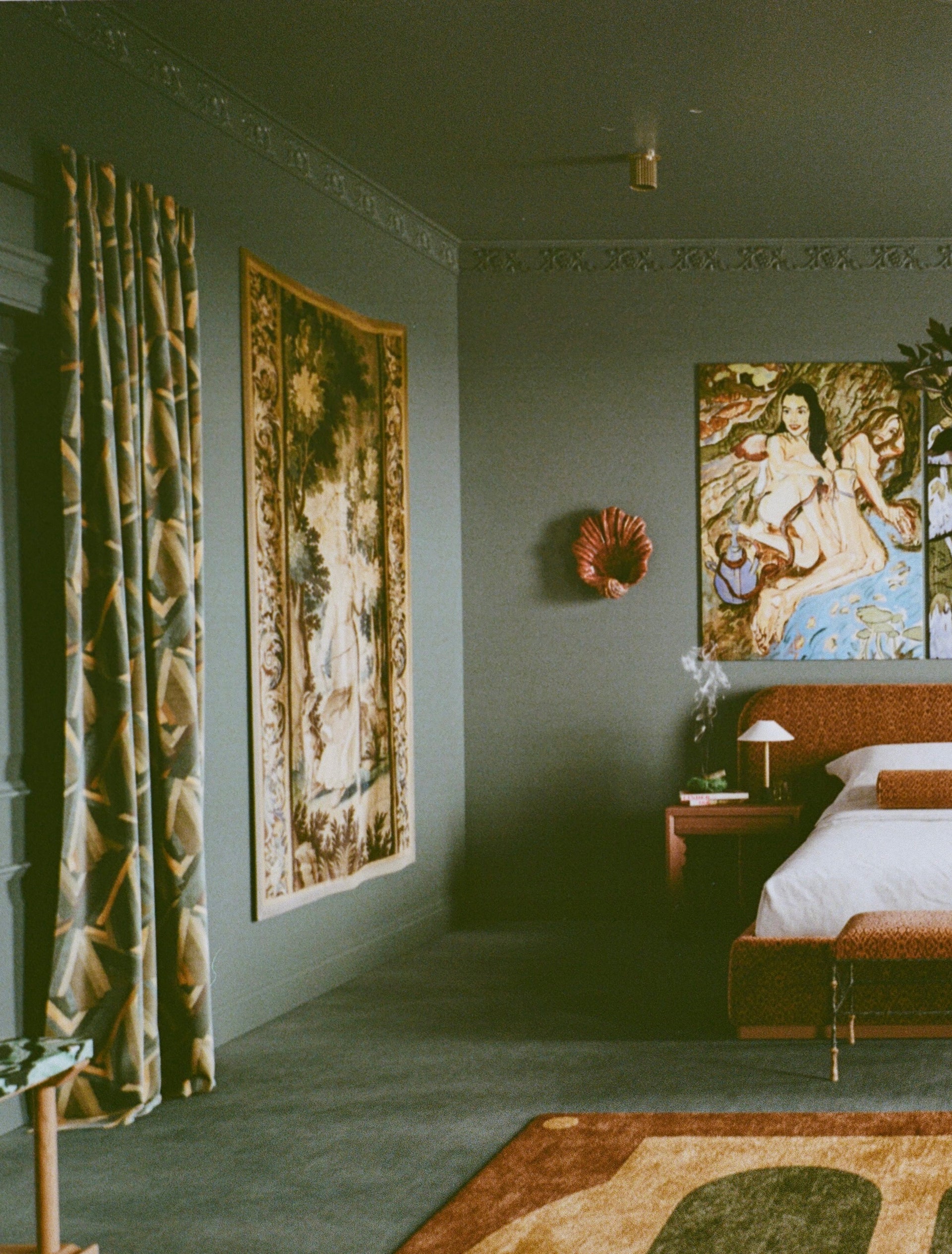 Vintage-style bedroom with tapestries, a bed, and decorative items.