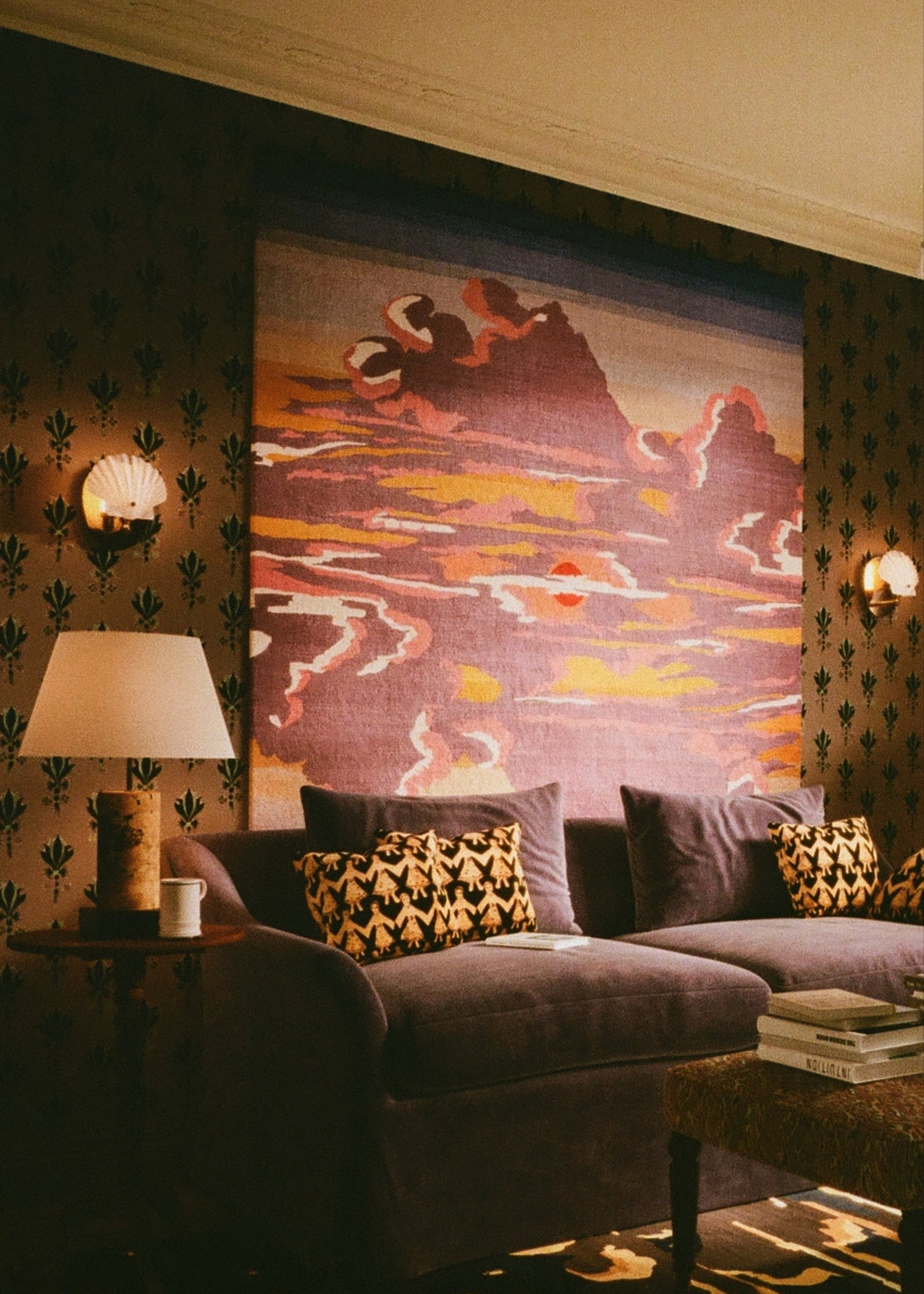 Living room with a large tapestry, sofa, and decorative pillows. SALON curates the finest unique handmade pieces from the interior industry's best makers and brands. Shop luxury furniture, lighting, rugs, art, antiques and vintage pieces and accessories from SALON interior designed rooms. 
