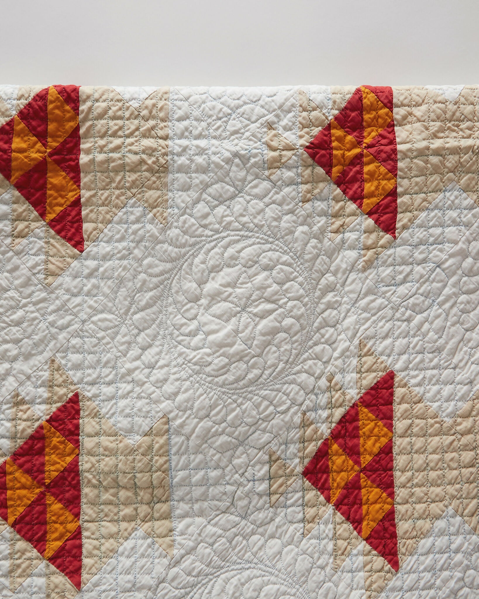 Quilt with red and yellow diamond patterns on a white background,  available  to buy on the-salon.com. SALON curates the finest , unique, handmade pieces from the interior industry's best makers and brands. Shop luxury furniture, lighting, rugs, art, antiques and vintage pieces and accessories from SALON interior designed rooms.