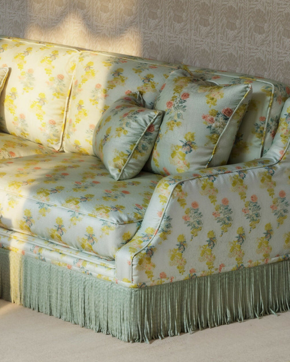Floral-patterned sofa in a living room setting with a yellow coffee table,  available  to buy on the-salon.com. SALON curates the finest , unique, handmade pieces from the interior industry's best makers and brands. Shop luxury furniture, lighting, rugs, art, antiques and vintage pieces and accessories from SALON interior designed rooms.
