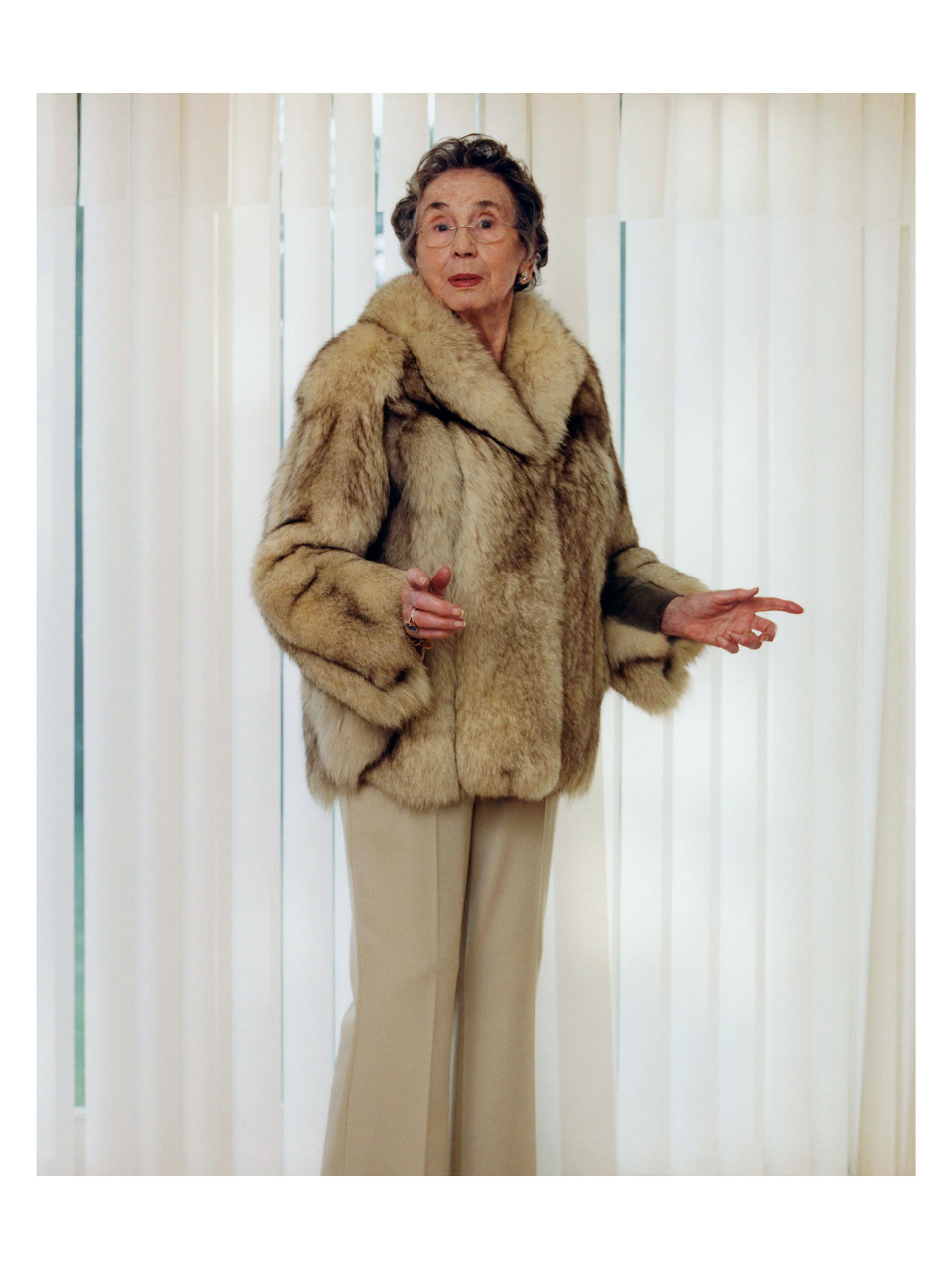 A photograph by Will Corry featuring a person wearing a fur coat, predominantly in a warm tone,  available  to buy on the-salon.com. SALON curates the finest , unique, handmade pieces from the interior industry's best makers and brands. Shop luxury furniture, lighting, rugs, art, antiques and vintage pieces and accessories from SALON interior designed rooms.
