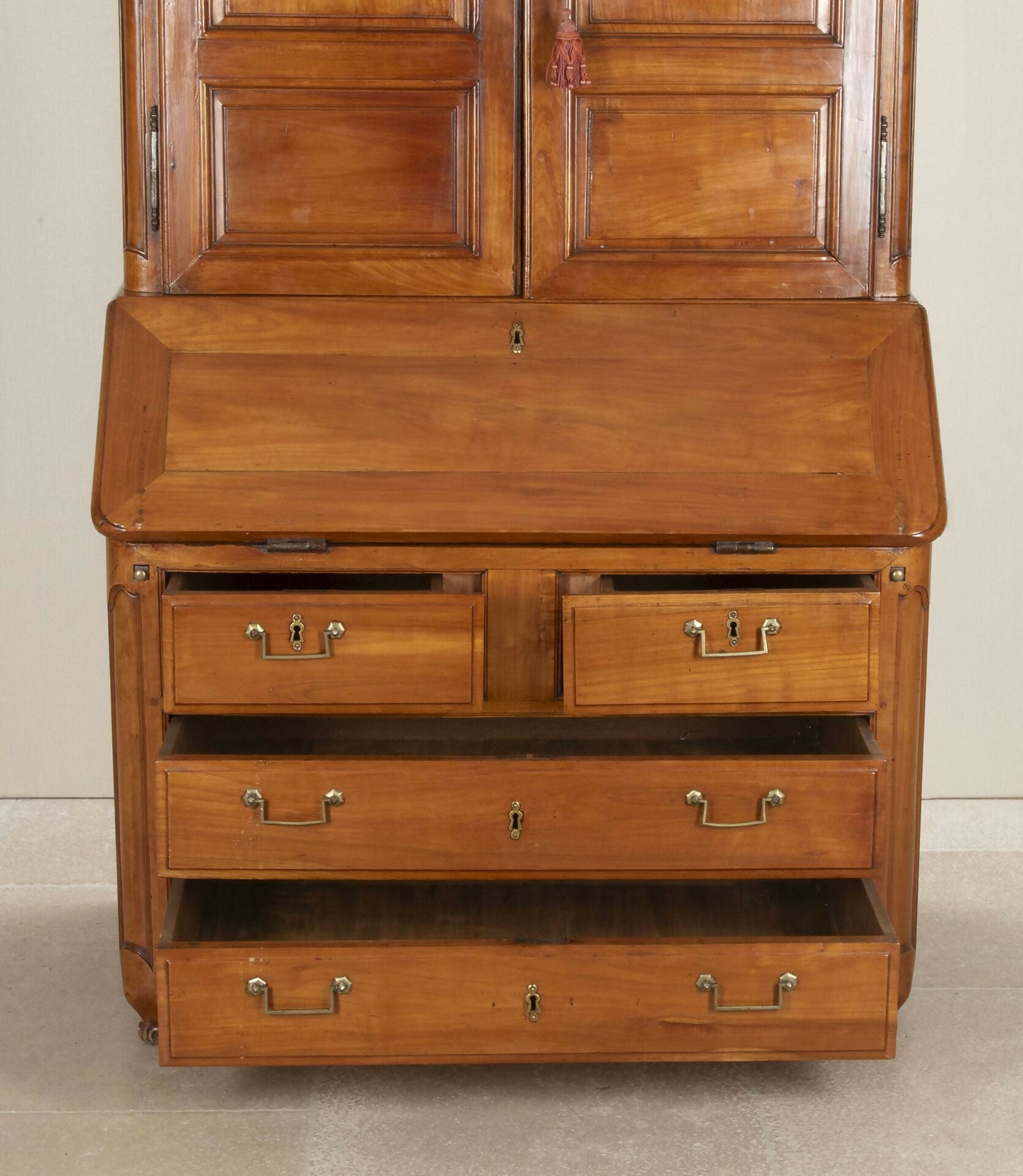 Wooden desk with multiple drawers and a closed top section on a neutral background,  available  to buy on the-salon.com. SALON curates the finest , unique, handmade pieces from the interior industry's best makers and brands. Shop luxury furniture, lighting, rugs, art, antiques and vintage pieces and accessories from SALON interior designed rooms.