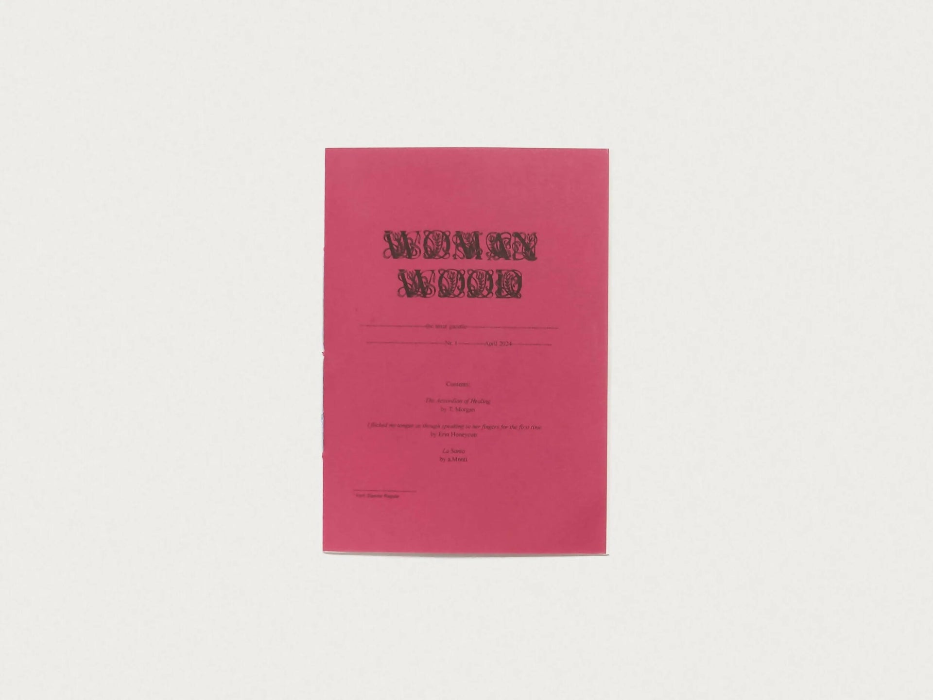 A red riso-printed zine with the title 'WOMANWOOD: THE SMUT GAZETTE #1' in white text on the cover, available  to buy on the-salon.com. SALON curates the finest , unique, handmade pieces from the interior industry's best makers and brands. Shop luxury furniture, lighting, rugs, art, antiques and vintage pieces and accessories from SALON interior designed rooms.