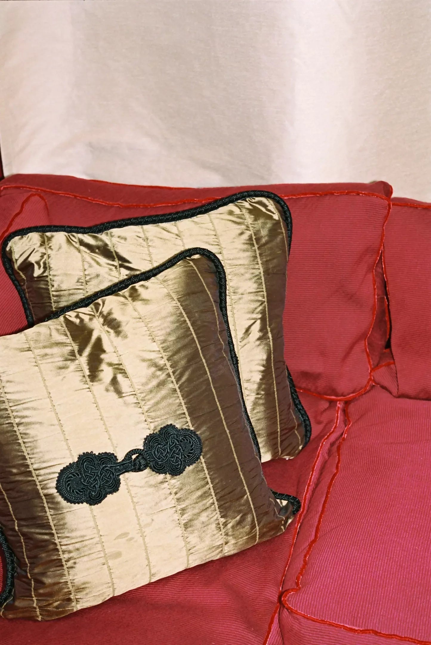 Close-up texture of a bronze-colored silk fabric with detailed stitching,  available  to buy on the-salon.com. SALON curates the finest , unique, handmade pieces from the interior industry's best makers and brands. Shop luxury furniture, lighting, rugs, art, antiques and vintage pieces and accessories from SALON interior designed rooms.