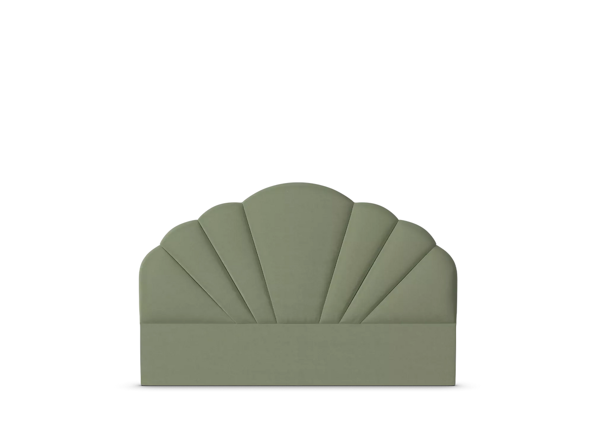 An upholstered headboard with a scalloped fan or shell-like top and a solid lower panel, shown in a muted sage green on a plain white background.