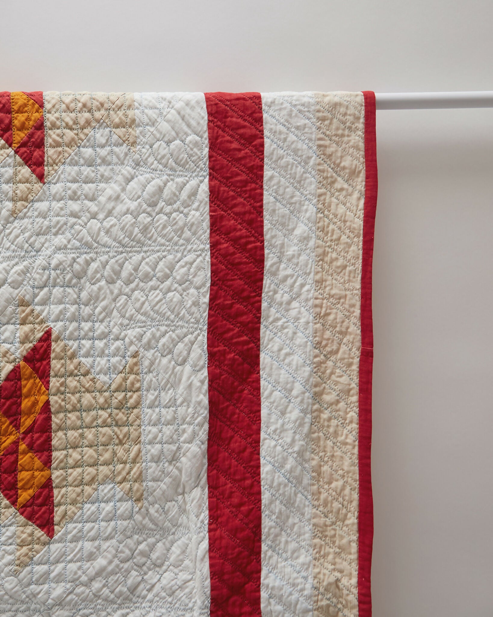 Quilt with red and white pattern on a hanger,  available  to buy on the-salon.com. SALON curates the finest , unique, handmade pieces from the interior industry's best makers and brands. Shop luxury furniture, lighting, rugs, art, antiques and vintage pieces and accessories from SALON interior designed rooms.