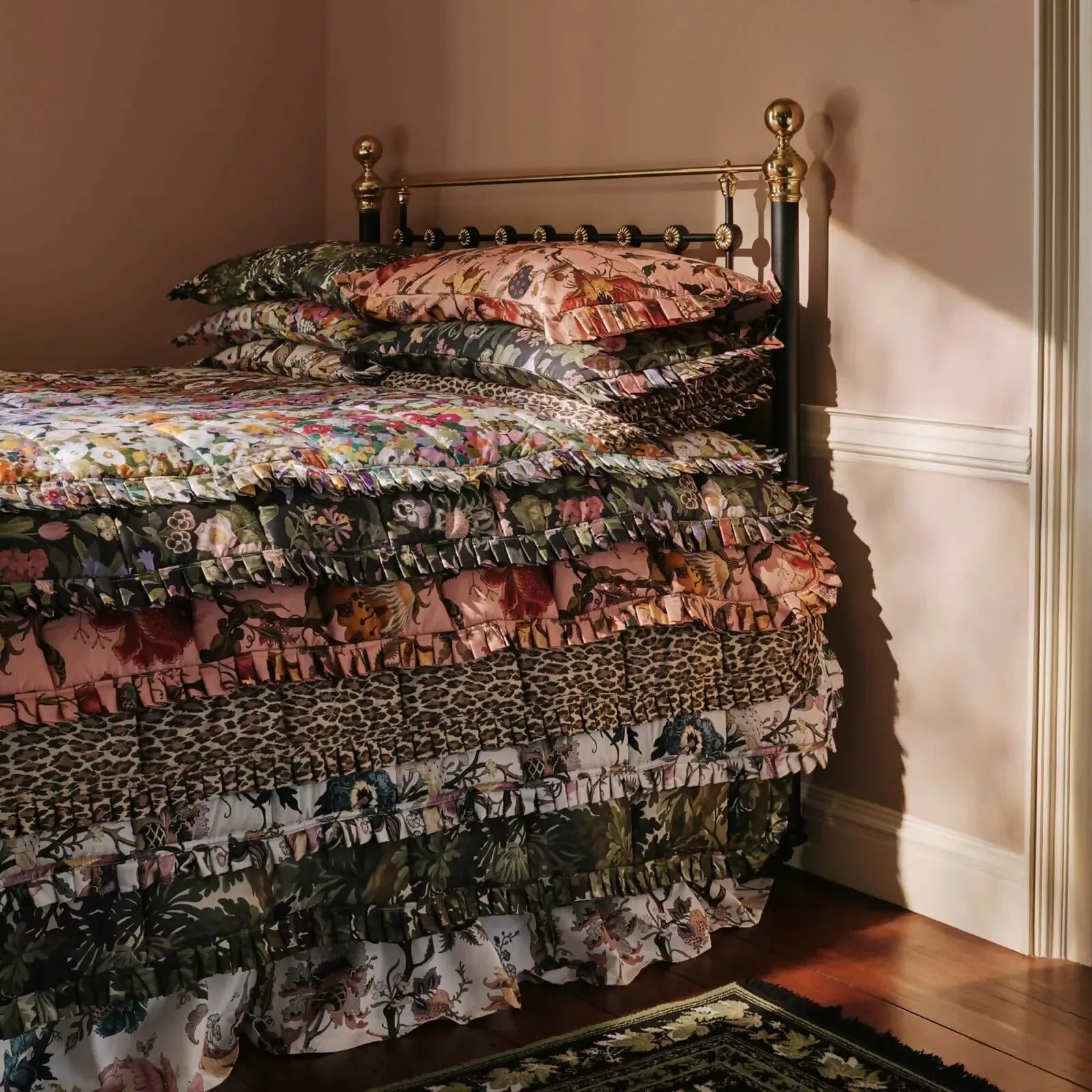 Bed with floral print bedding in a bedroom setting,available to buy from the-salon.com. SALON curates the finest unique handmade pieces from the interior industry's best makers and brands. Shop luxury furniture, lighting, rugs, art, antiques and vintage pieces and accessories from SALON interior designed rooms. 