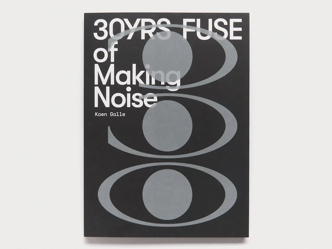 Cover of the book 'FUSE: 30YRS OF MAKING NOISE' with a black background featuring white and gray text and circular graphics representing sound or noise, available  to buy on the-salon.com. SALON curates the finest , unique, handmade pieces from the interior industry's best makers and brands. Shop luxury furniture, lighting, rugs, art, antiques and vintage pieces and accessories from SALON interior designed rooms.