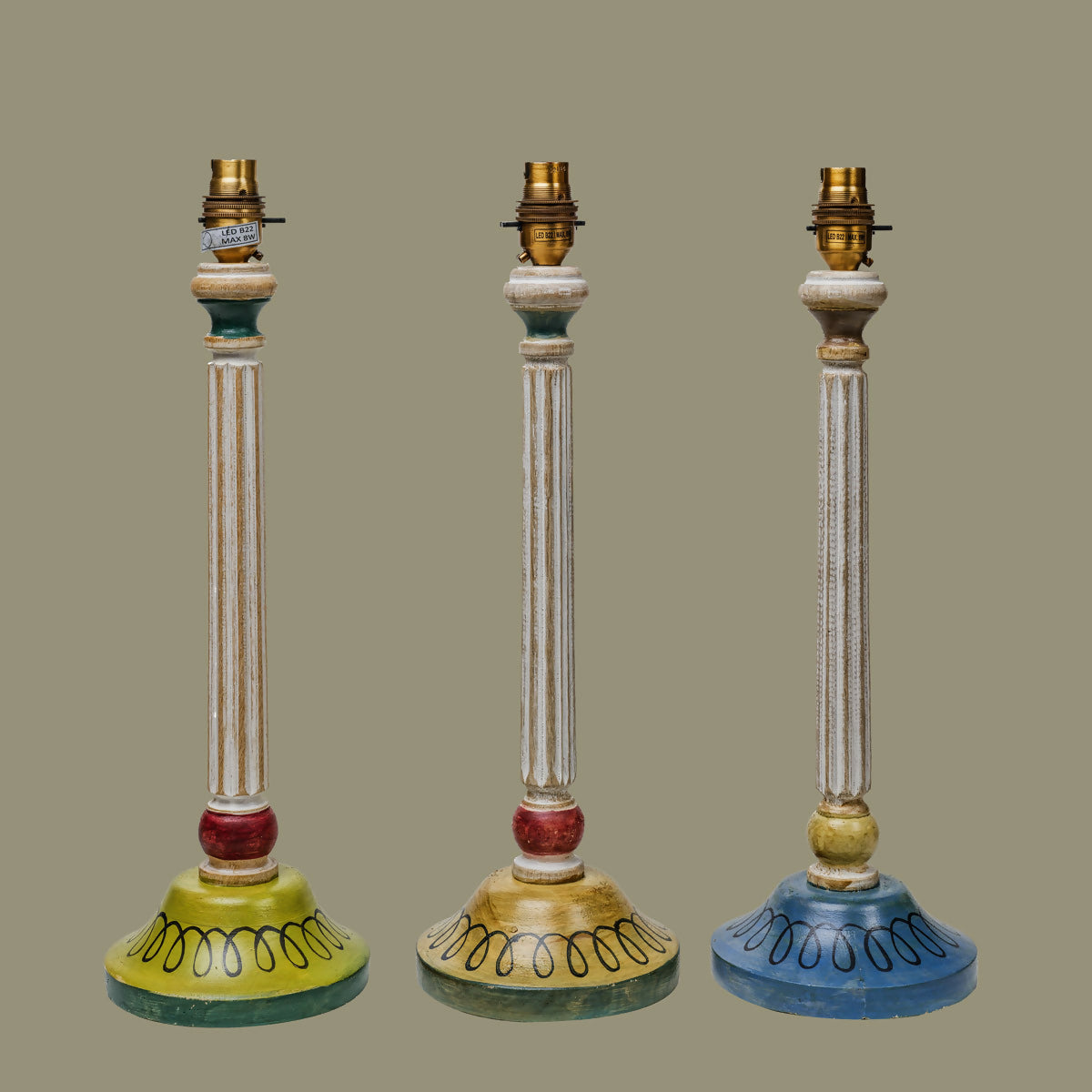 Three decorative lamp bases with colorful designs on a beige background,  available  to buy on the-salon.com. SALON curates the finest , unique, handmade pieces from the interior industry's best makers and brands. Shop luxury furniture, lighting, rugs, art, antiques and vintage pieces and accessories from SALON interior designed rooms.