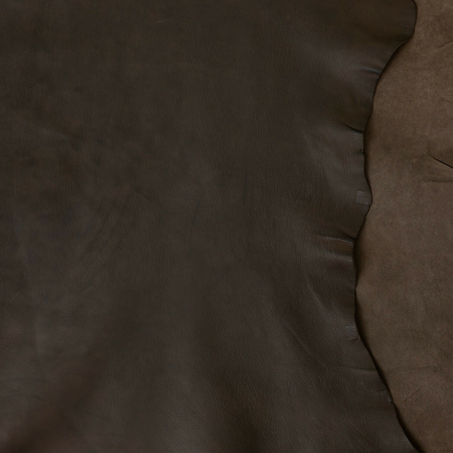 A close up on the leather feature of the brown wooden bedside table with a leather top,  available  to buy on the-salon.com. SALON curates the finest , unique, handmade pieces from the interior industry's best makers and brands. Shop luxury furniture, lighting, rugs, art, antiques and vintage pieces and accessories from SALON interior designed rooms.