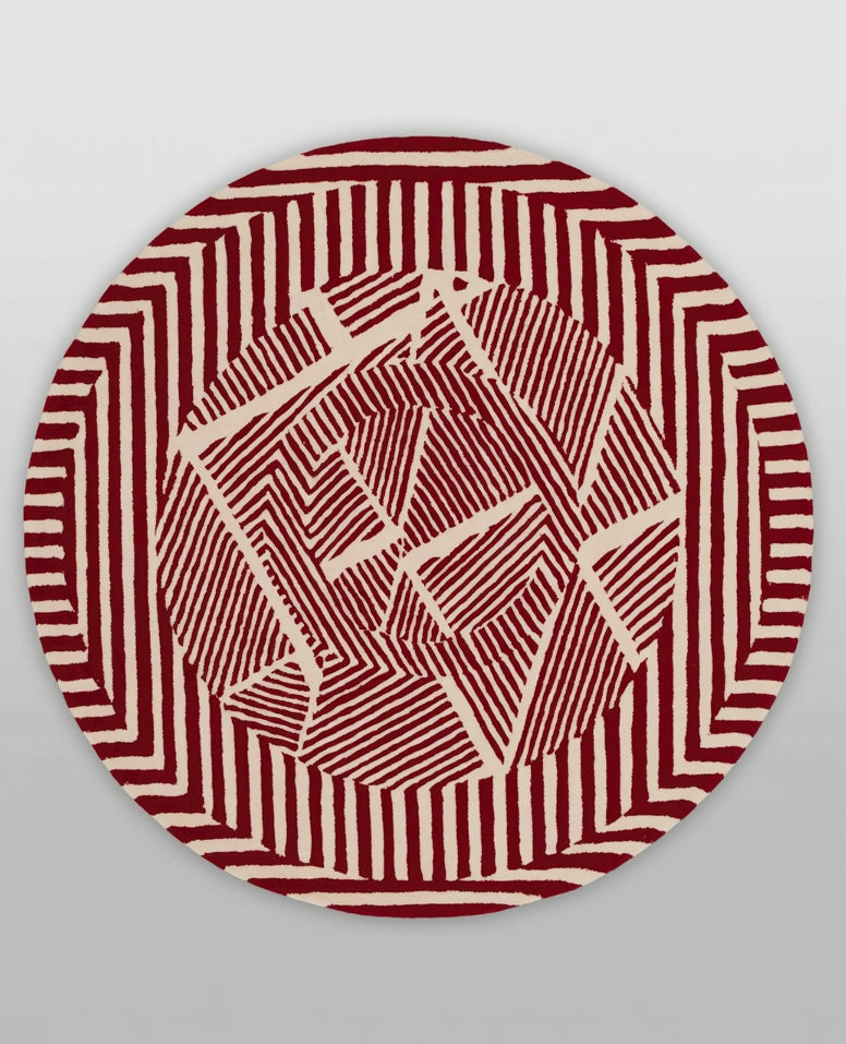 Round red and white patterned object on a light gray background