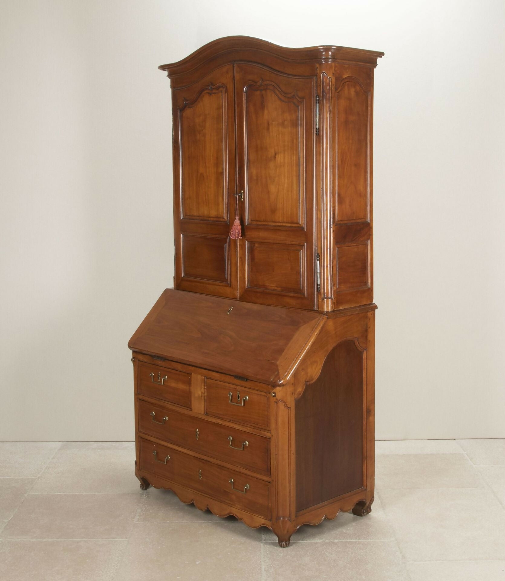 Wooden cabinet with a sloping desk on a white background,  available  to buy on the-salon.com. SALON curates the finest , unique, handmade pieces from the interior industry's best makers and brands. Shop luxury furniture, lighting, rugs, art, antiques and vintage pieces and accessories from SALON interior designed rooms.