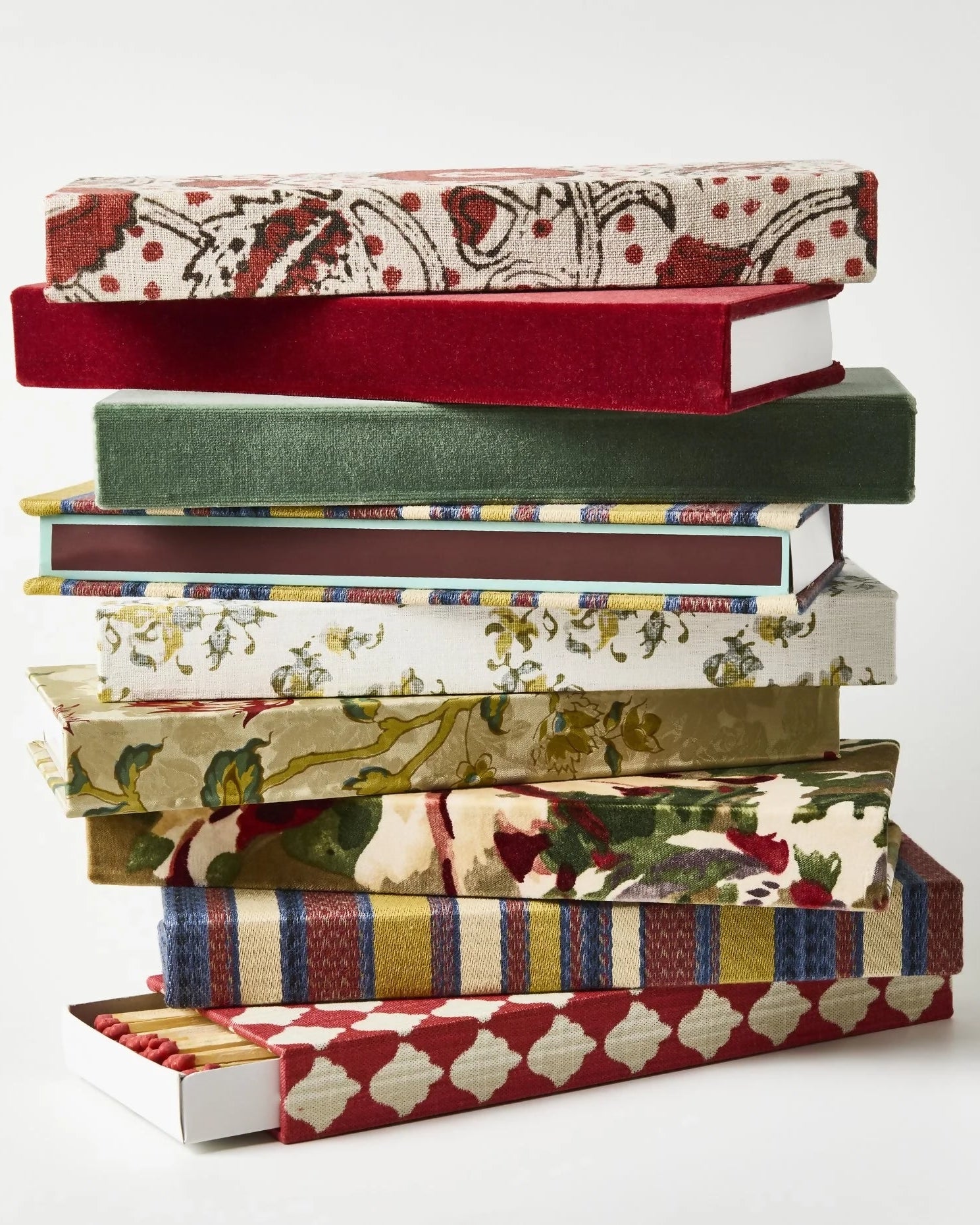Stack of books with patterned covers on a white background