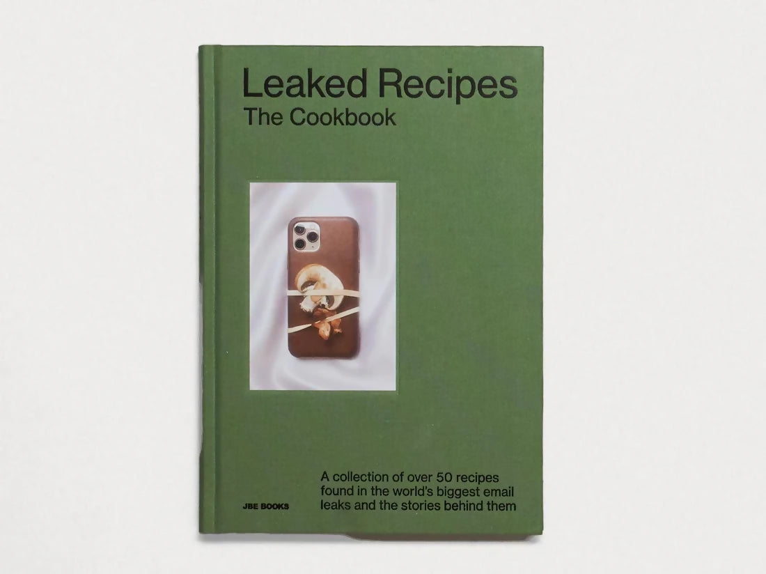 The cover of 'Leaked Recipes: The Cookbook' featuring a smartphone with a recipe on the screen, against a green background, available  to buy on the-salon.com. SALON curates the finest , unique, handmade pieces from the interior industry's best makers and brands. Shop luxury furniture, lighting, rugs, art, antiques and vintage pieces and accessories from SALON interior designed rooms.