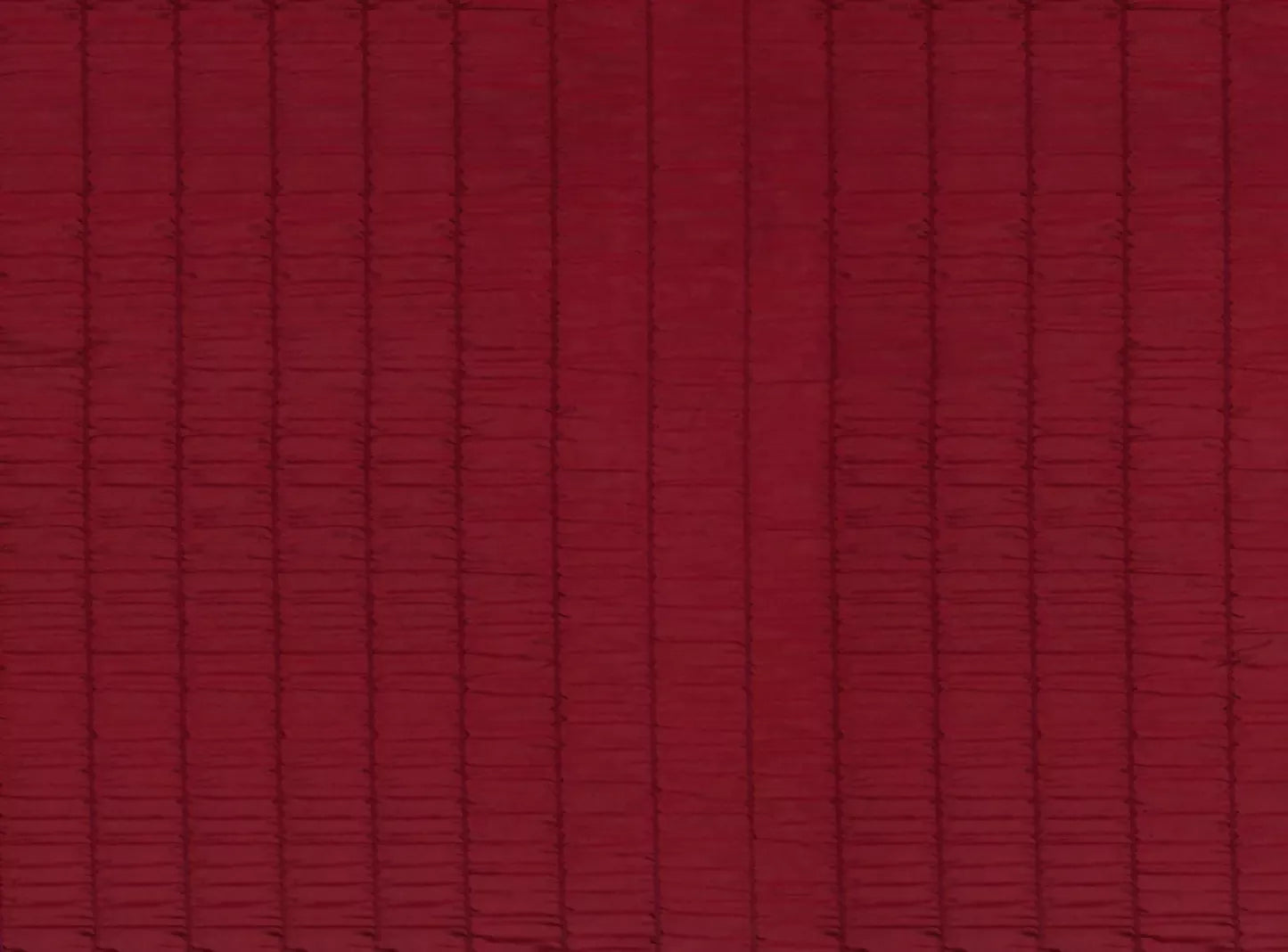 Close-up of a red textured fabric with subtle rouches, woven in the UK,  available  to buy on the-salon.com. SALON curates the finest , unique, handmade pieces from the interior industry's best makers and brands. Shop luxury furniture, lighting, rugs, art, antiques and vintage pieces and accessories from SALON interior designed rooms.